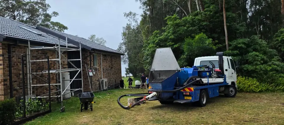 Pumpet truck parked beside a rural shed on a bushland property